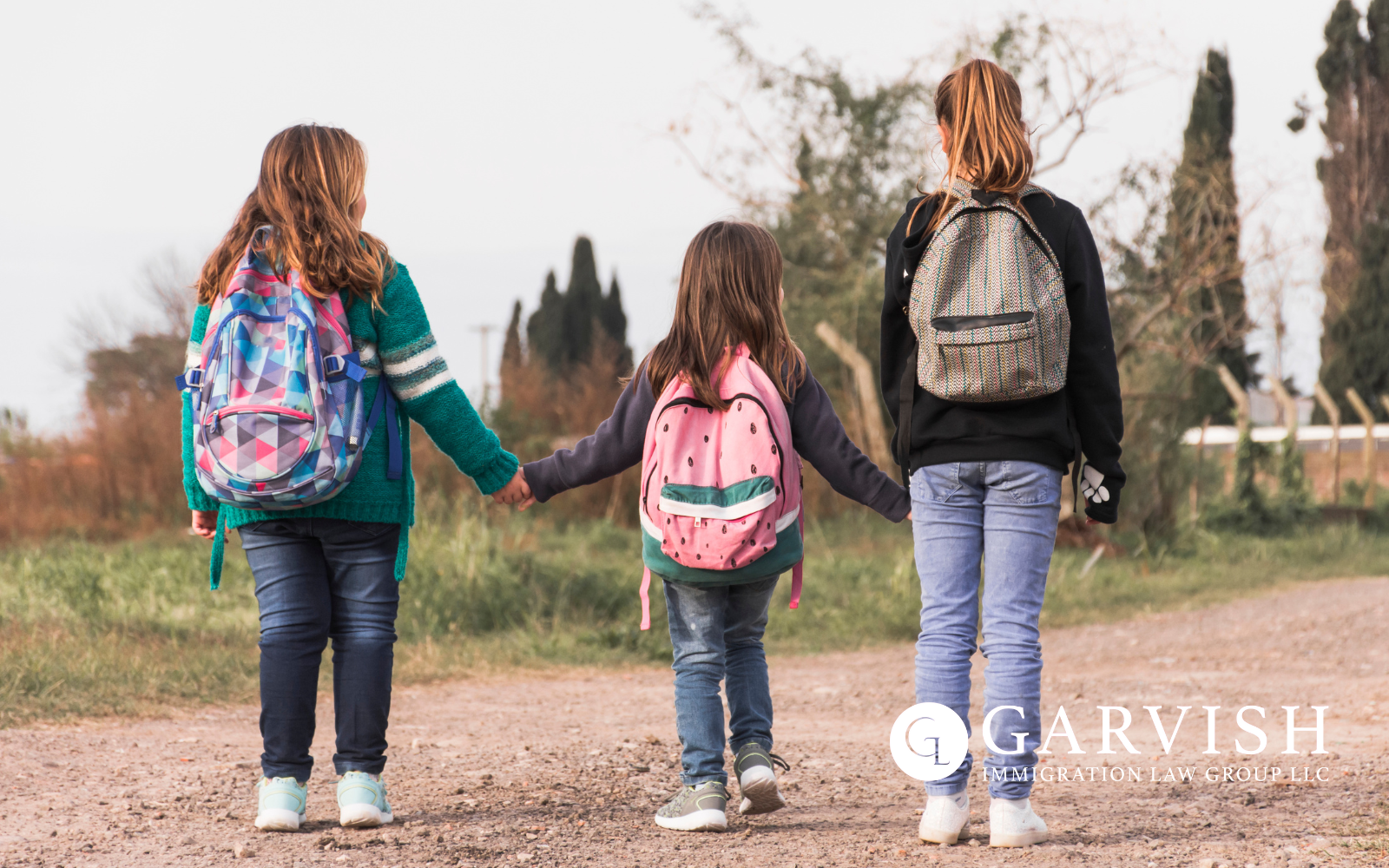Three Children walking away with backpacks