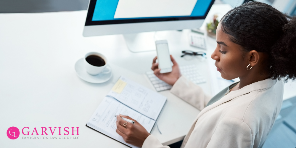 Blog Header Image. African American Woman Holding a phone as she reviews her paper planning calendar to schedule an appointment.